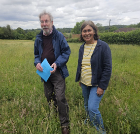 Cllrs Hussey and Hopkins standing in the Frieth wildflower meadow